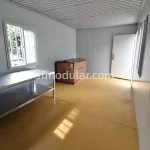 Empty interior space inside a modular container home with window and natural light