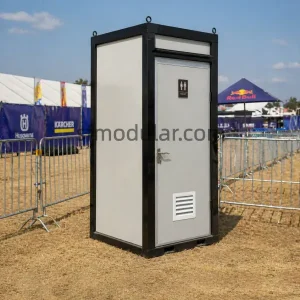 Mobile toilet unit installed at an outdoor event area for temporary public restroom use