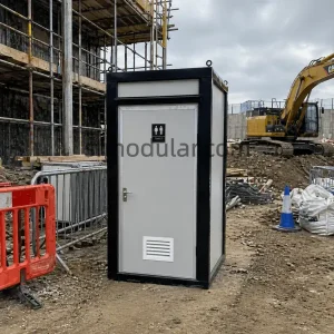 Mobile toilet unit placed on a construction site for temporary worker sanitation
