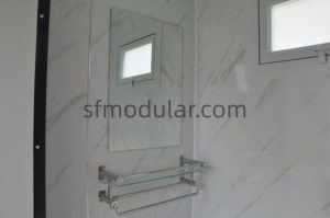 Wall storage shelf inside portable toilet with shower