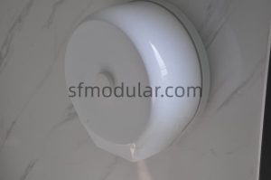 Tissue holder detail inside portable toilet with shower