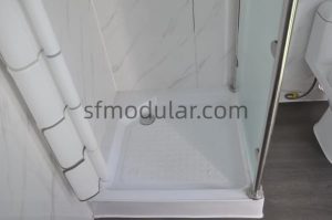 Floor detail inside portable toilet with shower unit