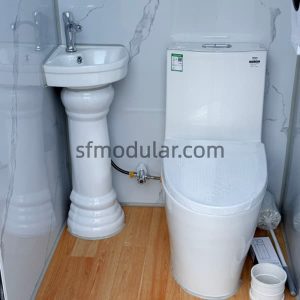Mobile toilet unit interior with toilet and hand wash facility for improved user hygiene
