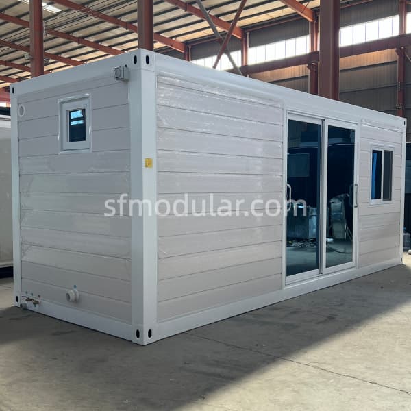 White granny pod exterior with sliding glass door and side window