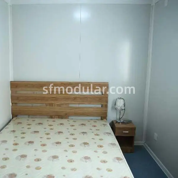 prefab-shelter-bedroom-layout-bedside-table Bedroom layout inside a prefab shelter with bed and bedside table