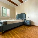 Bedroom interior of a 20ft container home with wood floor finish