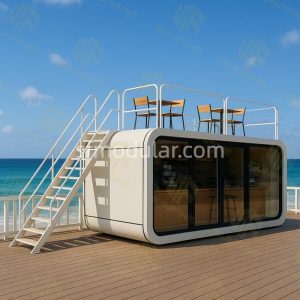 Apple Cabin modular coffee shop design with white exterior, curved roof, glass front and exterior staircase