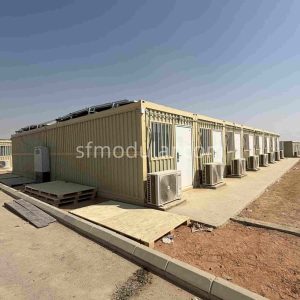 Modular temporary housing units arranged in a row for camp accommodation