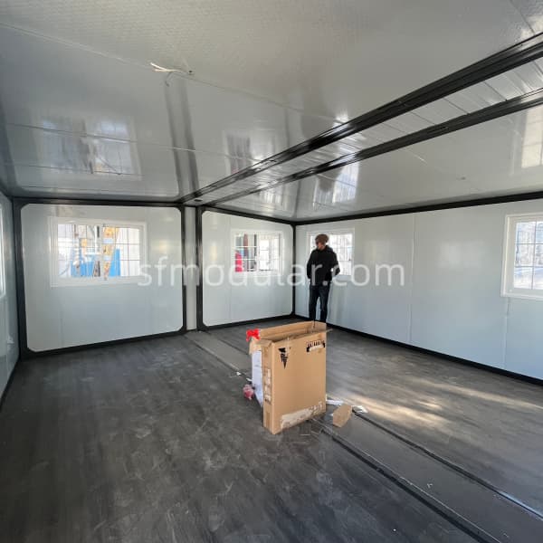 small-expandable-homes-spacious-interior-layout Spacious and bright interior of small expandable homes with wood-texture flooring and pre-installed white walls.