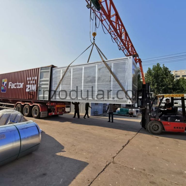 Loading a 20ft expandable container house onto a truck using a crane for export and global shipping